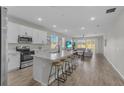 Open concept kitchen with island, stainless steel appliances, and white cabinets at 10157 Spring Lake Dr, Clermont, FL 34711