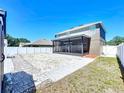 Expansive backyard featuring a screened-in porch, white rock bed, partial grass, and privacy fence at 1727 Wood Path, Auburndale, FL 33823