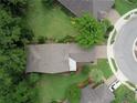 An aerial view shows the property's roof, driveway, landscaping, and neighborhood layout at 513 San Sebastian Ct, Davenport, FL 33837