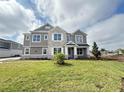 Attractive two-story home featuring stone accents, well-maintained lawn, and recent landscaping at 977 Hawksnest Pt, Oviedo, FL 32765