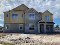 Two-story home featuring a mix of siding and stucco, complemented by large windows that brighten the facade at 977 Hawksnest Pt, Oviedo, FL 32765