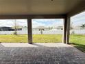 Relaxing covered patio with brick pavers overlooking a spacious fenced backyard at 977 Hawksnest Pt, Oviedo, FL 32765