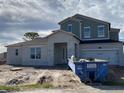 Two-story home featuring a two-car garage, covered porch, and a combination of stucco and siding at 987 Hawksnest Pt, Oviedo, FL 32765