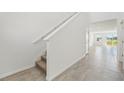 Bright hallway with neutral tile flooring, leading to a naturally lit open space at 2735 Virginia Pine Dr, Bartow, FL 33830