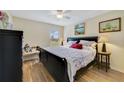 Cozy bedroom with a comfortable bed, ceiling fan, and natural light streaming through the window at 27601 Country Stone Ct, Leesburg, FL 34748
