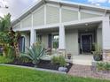 Charming home with a well-manicured front yard with lush landscaping and stone accents at 3811 Island Green Way, Orlando, FL 32824