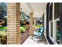 Relaxing front porch with rocking chairs and brick columns at 4034 Winderlakes Dr, Orlando, FL 32835