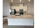 Modern kitchen with stainless steel appliances and large island at 5015 Dancy Ln, Saint Cloud, FL 34772