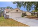 Exterior view of the house, showcasing the garage and front yard at 5160 Wood Ridge Ct, Ocoee, FL 34761