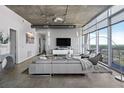 Spacious living room with floor to ceiling windows, modern furniture, and city views at 155 S Court Ave # 2908, Orlando, FL 32801