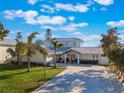 This gorgeous home features a well manicured lawn, metal roof, and a long, concrete drive at 25 Cunningham Dr, New Smyrna Beach, FL 32168