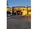 Main entrance to a resort with palm trees and landscaping at 12521 Floridays Resort Dr # 207F, Orlando, FL 32821