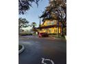 Exterior view of a building with a red car parked in the parking lot at 12521 Floridays Resort Dr # 207F, Orlando, FL 32821