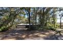 House exterior showcasing a carport and tree-lined street at 2663 Magnolia Rd, Deland, FL 32720