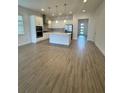Spacious kitchen with island, stainless steel appliances, and light-colored cabinetry at 2817 Willowseed Ln, Saint Cloud, FL 34772