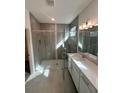 Spa-like bathroom with walk-in shower and double vanity at 4934 Shady Pines Dr, Saint Cloud, FL 34772