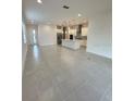 Open living room with modern kitchen and island at 5031 Dancy Ln, Saint Cloud, FL 34772