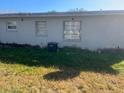 Simple backyard with grass and a visible AC unit at 5465 Lescot Ln, Orlando, FL 32811