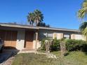 Ranch-style home with a well-maintained lawn and mature palm tree at 5465 Lescot Ln, Orlando, FL 32811