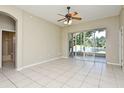 Bedroom featuring sliding glass doors leading to a screened lanai with serene lake views at 77 Spring Glen Dr, Debary, FL 32713