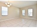 Spacious living room with neutral walls, tiled floors, and plenty of natural light from large windows at 77 Spring Glen Dr, Debary, FL 32713