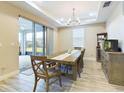 Formal dining room with a large wooden table, chairs, and access to a patio at 2506 Volunteer Ave, Kissimmee, FL 34744
