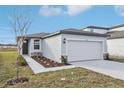 One story home with attached garage, landscaping, and dark gray door at 2522 Linda Knoll Ln, Bartow, FL 33830