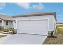 Attached garage with white door and stone accents at 2522 Linda Knoll Ln, Bartow, FL 33830