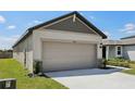 Two car garage with ample driveway space and stone accents at 2526 Linda Knoll Ln, Bartow, FL 33830