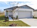 New house with gray garage door and light-colored exterior at 2538 Linda Knoll Ln, Bartow, FL 33830