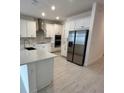 Spacious kitchen featuring stainless steel appliances and white cabinetry at 4946 Shady Pines Dr, Saint Cloud, FL 34772