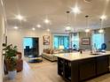 Open floor plan featuring an island kitchen that looks out into a living and dining space at 1664 Andover Ridge Dr, Deland, FL 32720