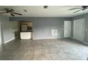 Open-concept living room seamlessly connects to the kitchen area with tile flooring at 2302 E Dana Dr, Deltona, FL 32738