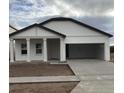 Two-story house with a white exterior, attached garage, and a front porch at 5710 Cattle Ranch Dr, Saint Cloud, FL 34771