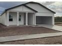 Newly constructed home with a white exterior, attached garage, and a front porch at 5710 Cattle Ranch Dr, Saint Cloud, FL 34771