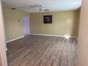 Spacious living room with updated flooring and a ceiling fan offering comfort and style at 11 Sandra Cir, New Smyrna Beach, FL 32168