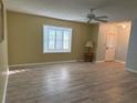 Inviting living room featuring a bright window, neutral paint, and a modern ceiling fan at 11 Sandra Cir, New Smyrna Beach, FL 32168
