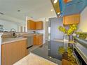 Modern kitchen with stainless steel appliances, updated cabinets, and a sleek black cooktop at 3258 Cranston St, Deltona, FL 32738