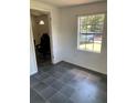 Bright living room with tiled floors and a large window, creating a comfortable and airy space at 766 Carlson Dr, Orlando, FL 32804