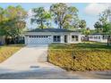 Beautifully renovated home with a well-manicured lawn and a spacious two-car garage at 765 W Lansdowne Ave, Orange City, FL 32763