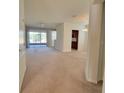 Spacious living room with plush carpeting, ample natural light, and a view of the screened lanai at 8343 Bella Tierra Ct # 8343, Davenport, FL 33896