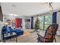 Cozy living room featuring a plush blue sectional, bright natural light, and modern accents at 1608 Bomi Cir, Winter Park, FL 32792