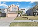 Two-story house with stone accents and a two-car garage at 2620 Sand Arbor Cir, Orlando, FL 32824