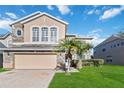 Two-story house with stone accents and a two-car garage at 2620 Sand Arbor Cir, Orlando, FL 32824
