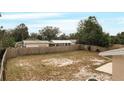 Large backyard with a wooden fence and mature trees at 1209 Baranova Rd, Ocoee, FL 34761