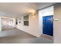 Building hallway with blue apartment door at 3171 Paradox Cir # 305, Kissimmee, FL 34746
