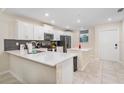 Modern kitchen with white cabinets and quartz countertops at 3171 Paradox Cir # 305, Kissimmee, FL 34746