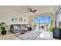 Inviting living room with a modern ceiling fan, decor, and a view of the water at 6336 Buford St # 705, Orlando, FL 32835