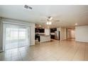 Open-concept living room featuring tile floors and a view of the kitchen at 1123 Union Ave, Mascotte, FL 34753