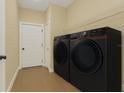 Well-appointed laundry room showcasing modern washer and dryer with ample shelving at 139 Malauka Pass, Ocklawaha, FL 32179